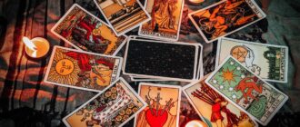 tarot reading with tarot card background and candlelight on the table for astrology occult magic spiritual horoscopes and palm reading fortune teller tarot reader free photo